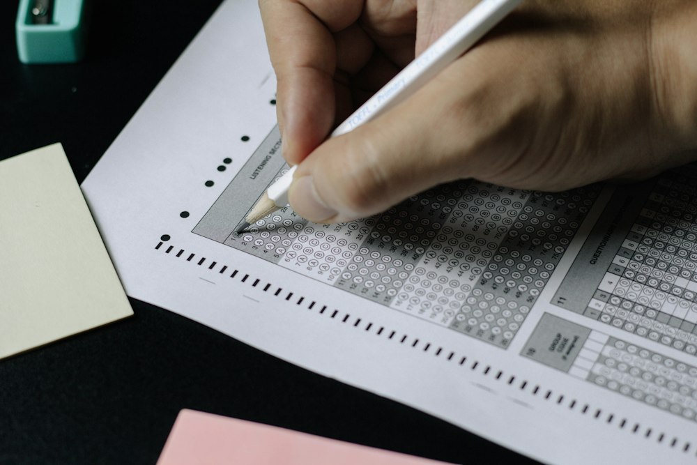Candidate filling in an exam answer sheet