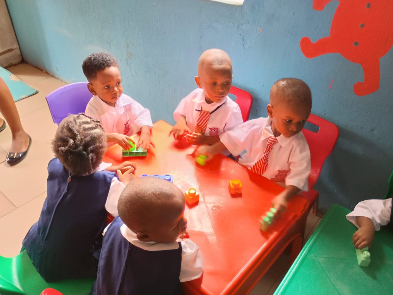 Nursery pupils playing with building toys at a classroom table