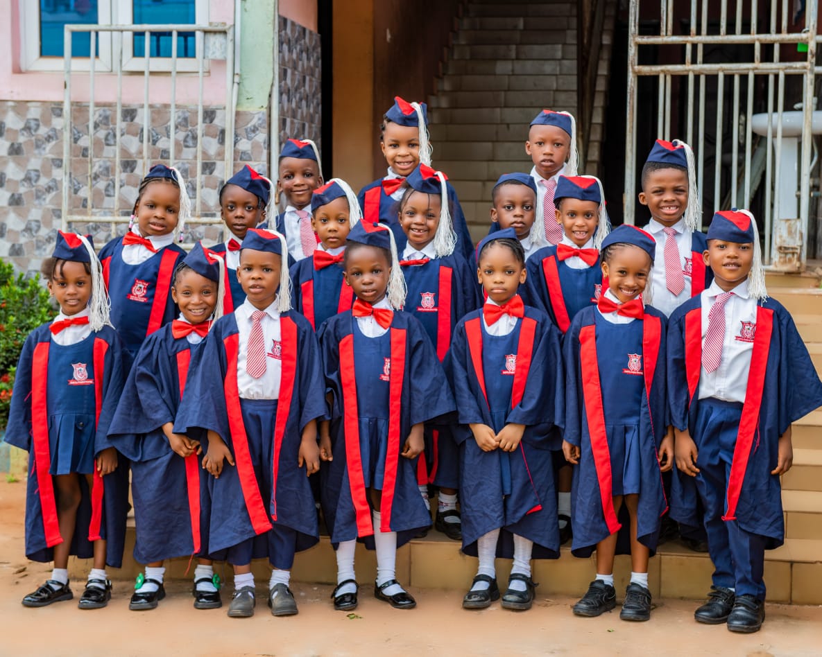 Grade School pupils in graduation gowns and caps